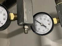 three pressure gauges on a pipe